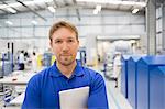 Portrait confident manager with digital tablet in steel factory