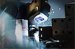 Welder using welding torch on steel in steel factory