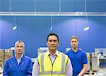 Portrait confident manager and workers in steel factory