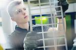 Focused worker examining piece in steel factory