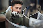 Worker measuring steel with calipers in steel factory