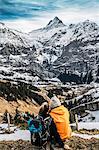 Couple looking at snowy mountain view, Grindelwald, Switzerland