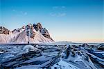 Woman standing among remote, icy landscape, Hofn, Iceland