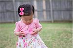 Toddler Girl Frowning as she Opens an Empty Easter Egg