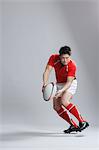 Portrait of Japanese rugby player throwing ball