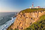 The Cabo da Roca lighthouse overlooks the promontory towards the Atlantic Ocean at sunset, Sintra, Portugal, Europe