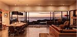 Home showcase interior overlooking ocean at sunset