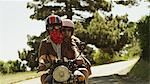 Young couple riding motorcycle on sunny road