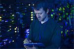 Server room technician taking notes on clipboard