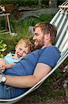 Sweden, Father and son (2-3) in hammock