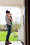 Sweden, Ostergotland, Vikbolandet, Woman carrying baby boy (6-11 months)