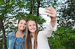 Sweden, Vastra Gotaland, Gothenburg, Two smiling girls (14-15) taking selfie