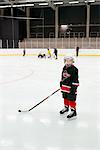Sweden, Young male hockey player (4-5) on ice
