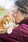 Sweden, Vastergotland, Fristad, Woman carrying and kissing cat