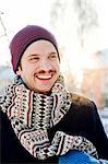 Sweden, Stockholm, Portrait of smiling man wearing scarf