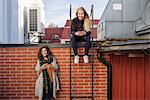 Sweden, Vasterbotten, Umea, Two young women using phones