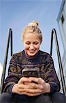 Sweden, Vasterbotten, Umea, Young woman using phone