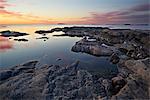 Sweden, Uppland, Stockholm Archipelago, Rocky coastline at sunset