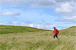 UK, Scotland, Shetland, Yell, Otterswick, Senior woman hiking in grassland