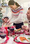 Woman cutting turkey at Christmas table