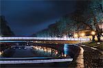 Finland, Varsinais-Suomi, Turku, Illuminated bridge over river at night