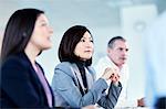 Attentive serious businesswoman listening in meeting