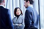 Attentive serious businesswoman listening to businessman