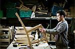 A man working in a furniture maker's workshop.