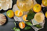 Overhead view of a table with sliced oranges and glasses.