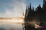 Senior man canoeing on lake