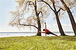 Woman with arm and leg raised in yoga position