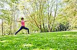 Woman, arms open, legs apart in yoga position