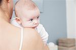 Mother holding baby boy, rear view, close-up