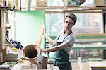 Woman in workshop making alphorn