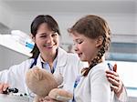 Pediatrician consulting with girl