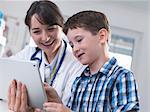 Doctor and boy using digital tablet