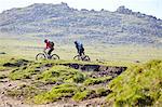 Cyclists cycling on hillside