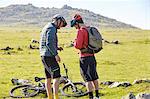 Cyclists on hillside chatting