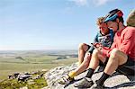 Cyclists resting on rocky outcrop