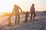 Parents with their children walking on the beach