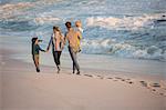 Rear view of a family walking on the beach