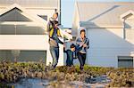 Happy family walking in front of a house