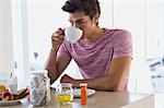 Close-up of an attractive young man drinking coffee