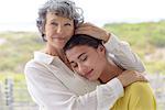 Loving mother hugging her adult daughter outdoors