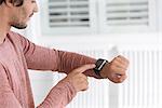 Young man using his smart watch