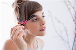 Close-up of a woman applying mascara