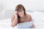 Close-up of beautiful woman reading a newspaper