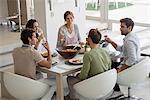 Group of happy friends having lunch at dining table