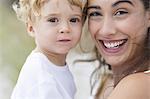 Portrait of a happy woman carrying her son