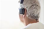 Senior man listening to music on headphones